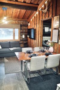 a dining room with a table with wine glasses on it at RukaTupasvilla in Ruka