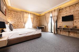 a bedroom with a large bed and a brick wall at Air Solief in Tashkent