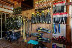 a wall filled with lots of different types of umbrellas at The Blue Cave Maldives in Kendhoo +56 photos