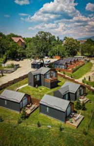 an overhead view of a group of houses on a field at Moon Village Comarnic in Sinaia +5 photos
