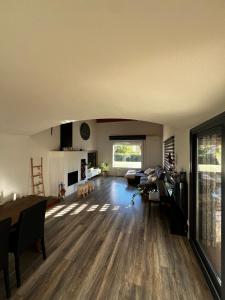 a large living room with a table and a couch at Cal Piano in Palol de Rebardit