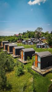 an overhead view of a row of houses in a field at Moon Village Comarnic in Sinaia