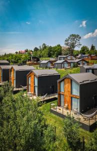 a group of houses in a field with trees at Moon Village Comarnic in Sinaia