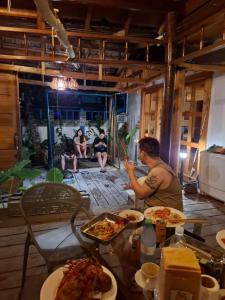 a man sitting at a table with plates of food at The Blue Cave Maldives in Kendhoo