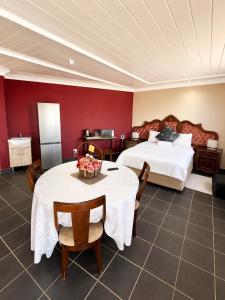 a hotel room with a bed and a table and chairs at Nairobi Guesthouse in Orkney