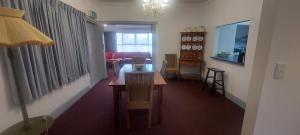 a living room with a table and a dining room at Mary's Place in Devonport