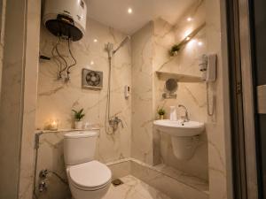 a bathroom with a toilet and a sink at Grand Duplex in Aswan