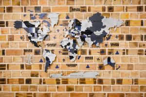 a brick wall with a map of the world on it at Air Solief in Tashkent