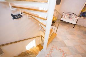 a winding staircase in a house with a chair at Holiday Home Smokovec in Vrbnik