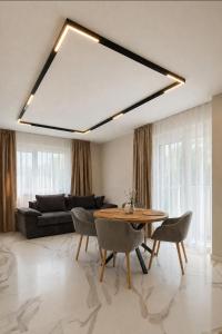 a living room with a table and a couch at Nikol River Residence in Sandanski