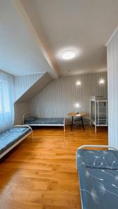 a room with two beds and a table in it at VIP hotel in Mukacheve +26 photos