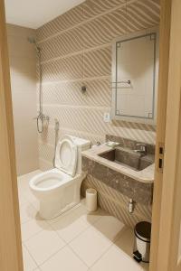 a bathroom with a toilet and a sink at فندق نخبة الجوار in Al Khansāk