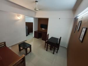 an overhead view of a living room with a table and chairs at Hovato Brown in Nedumbassery