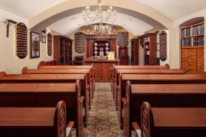 a church with wooden pews and a chandelier at Kosher Hotel King David Prague in Prague +60 photos