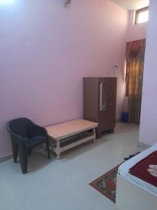 a bedroom with a bench and a chair and a cabinet at Hare Krishna hotel in Orchha +17 photos