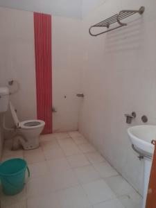 a bathroom with a toilet and a sink at Hare Krishna hotel in Orchha