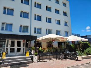 a hotel with bikes parked in front of a building at Jantar Economy in Szczecin