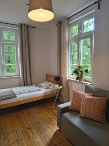 a living room with a couch and two windows at Widokówka in Łagów