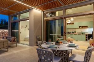 a dining room and kitchen with a table and chairs at Veragi Boutique Villas in Lefkada