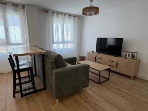 a living room with a couch and a tv at AMANITA VuT in Huerta del Rey