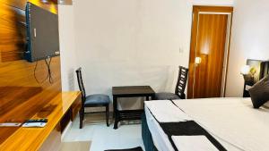 a bedroom with a desk and a bed and a table with chairs at HoTEL KAMAL VINTAGE in Kāthgodām +3 photos