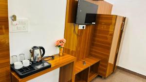 a wooden cabinet with a tv on top of it at HoTEL KAMAL VINTAGE in Kāthgodām
