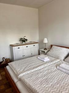 a bedroom with a large bed with a plant on it at Linden House in Sklené