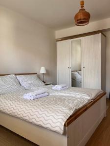 a bedroom with a large bed with two towels on it at Linden House in Sklené