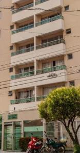 a building with a motorcycle parked in front of it at Lindo quarto centro Uberlândia in Uberlândia