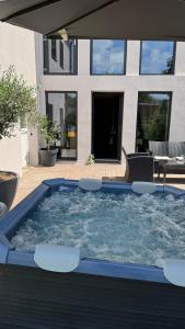 a large plunge pool with chairs and a house at My Wellness Ferienwohnung in Bullay
