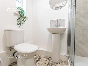 a bathroom with a toilet and a sink and a shower at Modern Serviced Apartments in St Helens with Free WiFi Ideal for Leisure or Work Stays by North West Accommodation in Saint Helens +51 photos