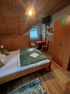 a bedroom with a bed and a table in a room at Willa Zwinka in Szczawnica