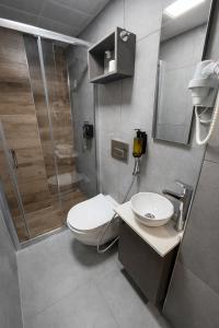 a bathroom with a toilet and a sink and a shower at D'Premium in Edirne +22 photos