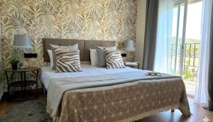 a bedroom with a large bed with a large window at Marbella Views in Ojén +22 photos