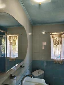 a bathroom with a sink and a toilet and a mirror at Parga Heritage in Parga +19 photos