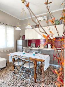 a kitchen with a table and chairs in a room at Parga Heritage in Parga