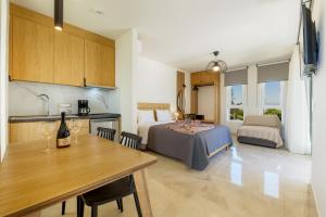 a kitchen and a bedroom with a bed and a table at Jechrina in Kato Daratso