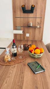 a table with two glasses of wine and a bowl of fruit at Ikigai Ascona in Ascona