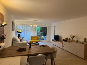 a person sitting on a couch in a living room at Ikigai Ascona in Ascona