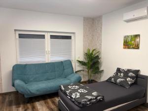 a living room with a couch and a chair at Sam Apartments LU/Oppau in Ludwigshafen am Rhein