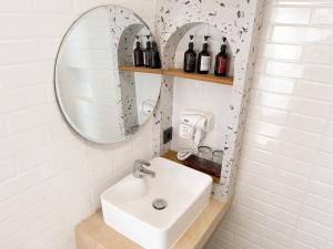 a bathroom with a sink and a mirror at Ayodhya Villa Patran in Kejayan