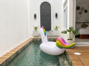 an inflatable pool in a house with an inflatable pool slide at Ayodhya Villa Patran in Kejayan