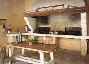 a kitchen with a wooden table in a room at Les Carmes and spa in Le Thor