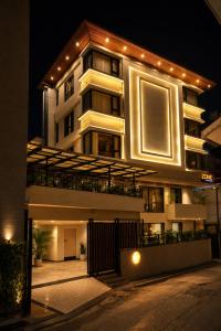 a large white building with lights on it at night at Zone by The Park Darjeeling in Darjeeling +35 photos