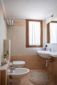 a bathroom with a sink and a toilet at Hotel Funivia in Chiesa in Valmalenco +71 photos