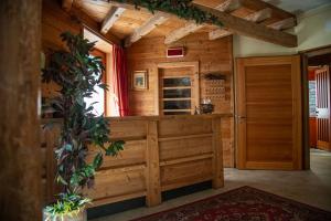 a wooden room with a door in a cabin at Hotel Funivia in Chiesa in Valmalenco