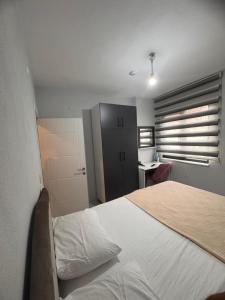a bedroom with a large bed and a desk at miamia apart otel in Trabzon