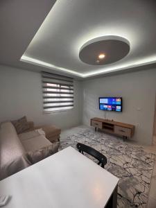 a living room with a couch and a tv at miamia apart otel in Trabzon