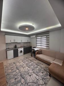 a large living room with a couch and a kitchen at miamia apart otel in Trabzon