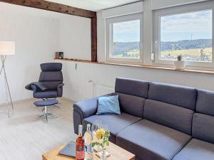 a living room with a couch and two chairs at Apartment Blackforest Birdnest by Interhome in Schonach +21 photos